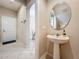 Small powder room with pedestal sink and mirror at 452 Harbor Winds Ct, Winter Springs, FL 32708