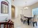 Bright dining room with tile floor, chandelier, and a marble-top table at 452 Harbor Winds Ct, Winter Springs, FL 32708