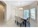 Dining room features tile floors, a chandelier, and a marble-top table at 452 Harbor Winds Ct, Winter Springs, FL 32708