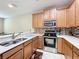 Modern kitchen with stainless steel appliances and ample wood cabinets at 452 Harbor Winds Ct, Winter Springs, FL 32708