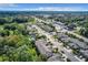 An aerial view of a residential neighborhood with houses, roads, and lush green surroundings at 452 Harbor Winds Ct, Winter Springs, FL 32708