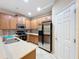 Kitchen boasts stainless steel appliances and wood cabinets at 452 Harbor Winds Ct, Winter Springs, FL 32708