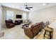 Relaxing living room featuring leather furniture and a ceiling fan at 452 Harbor Winds Ct, Winter Springs, FL 32708