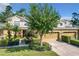 Two-story townhome with a two-car garage and manicured lawn at 452 Harbor Winds Ct, Winter Springs, FL 32708