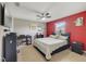 Bright bedroom with a red accent wall and ceiling fan at 3349 Rodrick Cir, Orlando, FL 32824
