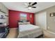 Serene bedroom with a red accent wall and ceiling fan at 3349 Rodrick Cir, Orlando, FL 32824