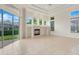 Bright Gathering room with fireplace and large windows at 9106 Panzani Pl, Windermere, FL 34786
