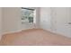 Bright bedroom with neutral carpeting and ample closet space at 9106 Panzani Pl, Windermere, FL 34786
