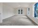 Large bedroom featuring two windows with gray carpeting at 9106 Panzani Pl, Windermere, FL 34786