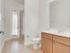 Clean bathroom with shower, toilet, vanity, and exterior access at 9106 Panzani Pl, Windermere, FL 34786