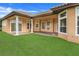 Landscaped backyard with covered patio and lush lawn at 9106 Panzani Pl, Windermere, FL 34786