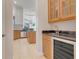 Butler's pantry with wine cooler and granite countertop at 9106 Panzani Pl, Windermere, FL 34786