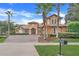 Two-story house with brick driveway and palm trees at 9106 Panzani Pl, Windermere, FL 34786