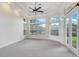 Main bedroom with ceiling fan, large windows, and access to the patio at 9106 Panzani Pl, Windermere, FL 34786