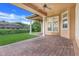 Covered patio with brick pavers and access to backyard at 9106 Panzani Pl, Windermere, FL 34786