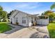 White house with carport and well-manicured lawn at 148 Merida Dr, Kissimmee, FL 34743