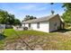 House exterior view with a large backyard and a patio at 148 Merida Dr, Kissimmee, FL 34743