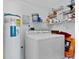 Laundry room with washer, dryer, and storage shelves at 148 Merida Dr, Kissimmee, FL 34743