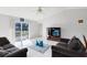 Living room with sliding glass doors leading to the backyard at 148 Merida Dr, Kissimmee, FL 34743