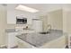 Efficient kitchen featuring granite countertops and white cabinetry at 5005 Laguna Bay Cir # 19, Kissimmee, FL 34746