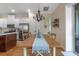 Charming dining area with rustic wood table and chandelier at 4907 W Fountainwood Dr, Saint Cloud, FL 34772