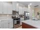 Well-equipped kitchen, featuring stainless steel appliances and white cabinetry at 4907 W Fountainwood Dr, St Cloud, FL 34772