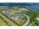 Aerial view of a community with houses near a lake and resort amenities at 4907 W Fountainwood Dr, St Cloud, FL 34772