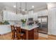 Modern kitchen with white cabinets, island, and hardwood floor at 4907 W Fountainwood Dr, St Cloud, FL 34772