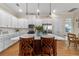 Spacious kitchen with white cabinets, stainless steel appliances, and a large island at 4907 W Fountainwood Dr, St Cloud, FL 34772