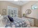 Guest bedroom with a comfortable bed, dresser, and window shutters at 4907 W Fountainwood Dr, St Cloud, FL 34772