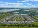 Aerial view of a lakefront community with numerous houses and green spaces at 4907 W Fountainwood Dr, St Cloud, FL 34772
