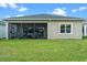 Large backyard with screened-in patio and grassy area at 4907 W Fountainwood Dr, St Cloud, FL 34772