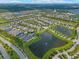 Aerial view of a neighborhood with houses, lakes, and roads at 4907 W Fountainwood Dr, St Cloud, FL 34772