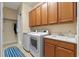 Laundry room with washer, dryer and storage cabinets at 4907 W Fountainwood Dr, St Cloud, FL 34772