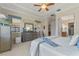 Main bedroom with king bed, dresser, and access to the bathroom at 4907 W Fountainwood Dr, St Cloud, FL 34772