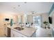 Modern kitchen with island, stainless steel appliances, and white cabinetry at 4804 Memories Ln, Kissimmee, FL 34746
