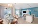 Open dining room with glass table, white chairs, and access to the pool at 4804 Memories Ln, Kissimmee, FL 34746