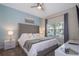 King-size bed, tufted headboard, and neutral color palette create a relaxing atmosphere at 4804 Memories Ln, Kissimmee, FL 34746