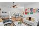 Open concept living room with hardwood floors and view to dining and kitchen at 8692 Vesta Ter, Orlando, FL 32825