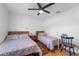 Bedroom with two twin beds, a desk, and ceiling fan at 8692 Vesta Ter, Orlando, FL 32825