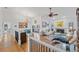 Open concept living room with hardwood floors, and a view of the dining area at 8692 Vesta Ter, Orlando, FL 32825