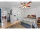 Bedroom with a view into the bathroom and a striped bedspread at 8692 Vesta Ter, Orlando, FL 32825