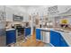 Updated kitchen with blue cabinets, stainless steel appliances and a large island at 8692 Vesta Ter, Orlando, FL 32825