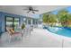 Inviting pool area with patio furniture, lush landscaping, and a covered patio at 8692 Vesta Ter, Orlando, FL 32825