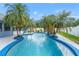 Relaxing kidney-shaped pool surrounded by lush tropical plants at 8692 Vesta Ter, Orlando, FL 32825
