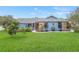 Cute light blue house with well-maintained lawn and landscaping at 8692 Vesta Ter, Orlando, FL 32825