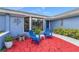 Inviting red brick patio with blue chairs and landscaping at 8692 Vesta Ter, Orlando, FL 32825