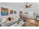 Living room with hardwood floors, comfortable seating and large windows at 8692 Vesta Ter, Orlando, FL 32825