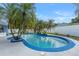 Large kidney shaped pool with surrounding tropical landscaping at 8692 Vesta Ter, Orlando, FL 32825