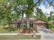 Brick ranch house with attached garage and landscaping at 1469 Grace Lake Cir, Longwood, FL 32750